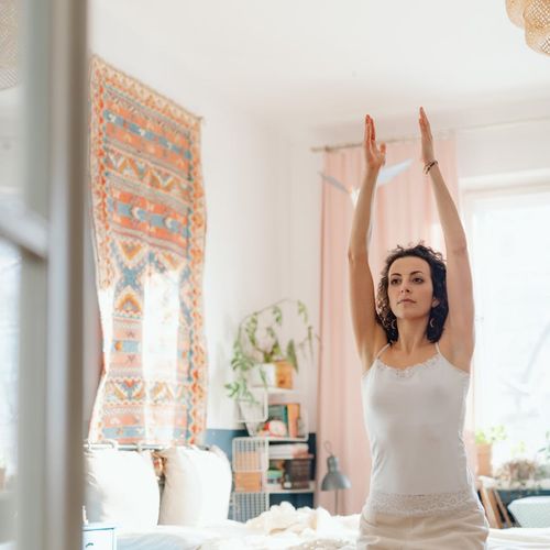 Woman in a calm, focused state during a light exercise routine.